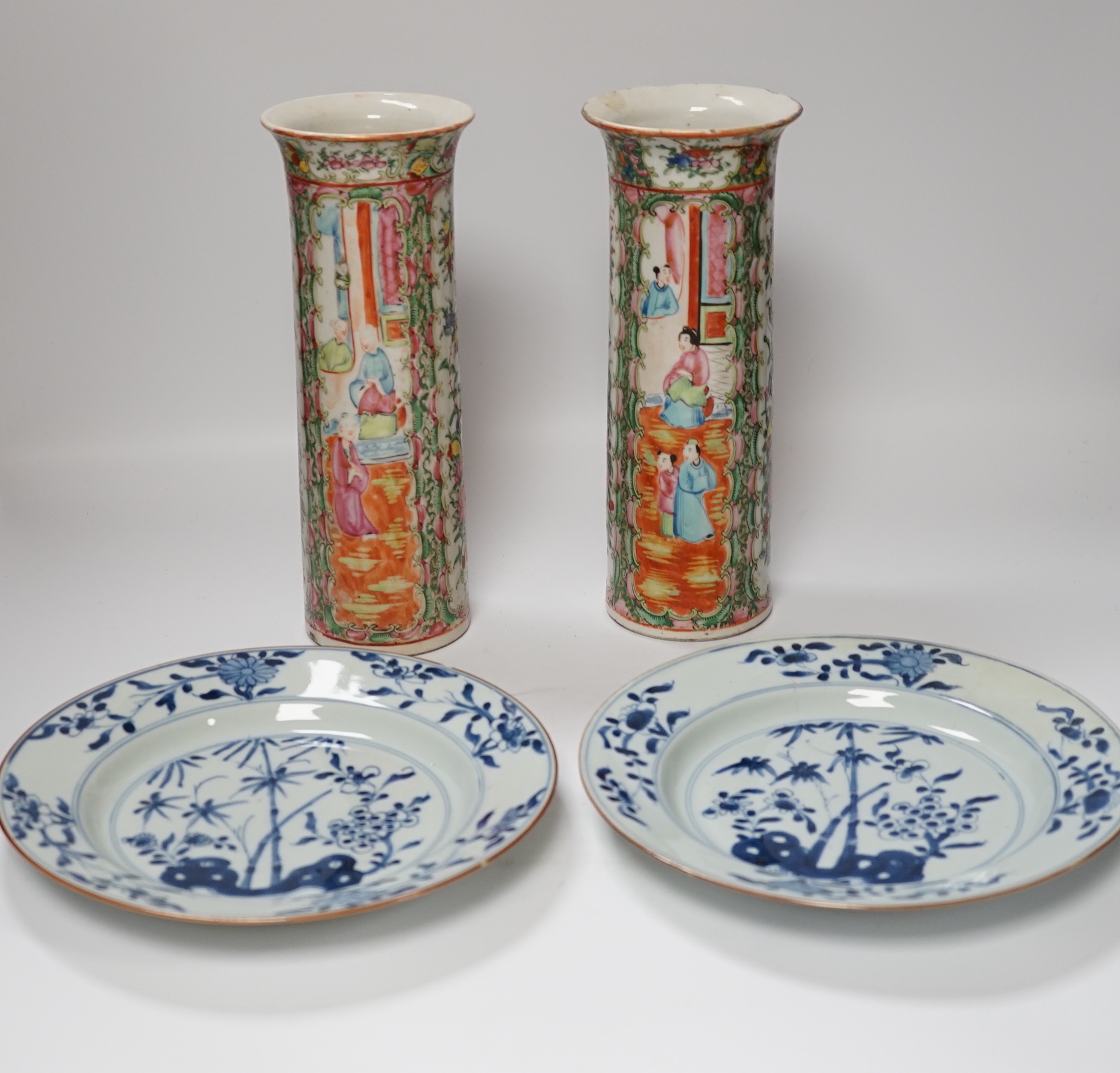 A pair of 19th century Chinese famille rose sleeve vases and a pair of 18th century Chinese blue and white plates, vases 26.5cm